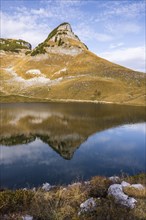 Lake Augstsee and the Atterkogel mountain on the Loser. Autumn, good weather, blue sky. Reflection.