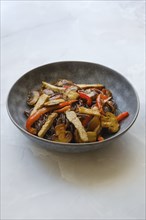 Stir fried pork meat with mushrooms and black rice noodles