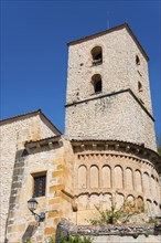 High stone tower with windows and old masonry under a clear blue sky, Iglesia de Santiago, church,