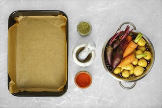 Overhead view of fresh vegetables and spices for baking on kitchen countertop