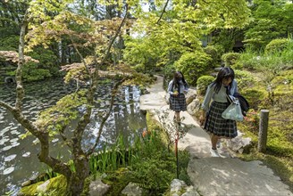 School girls stroll through Tenjuan Gardens, Nanzen-ji temple complex, Kyoto, Japan, Asia