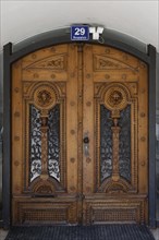 Decorative antique wooden door with ornate carvings, main square 29, Villach, Carinthia, Austria,