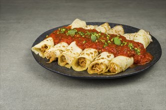 Brazilian pancakes with chicken, tomato bolognese sauce, rolled pancakes