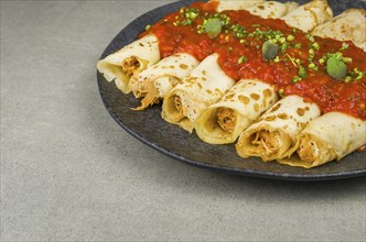 Brazilian pancakes with chicken, tomato bolognese sauce, rolled pancakes