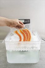 Sous vide cooking of papaya in a sous vide precision immersion cooker with water and water balls