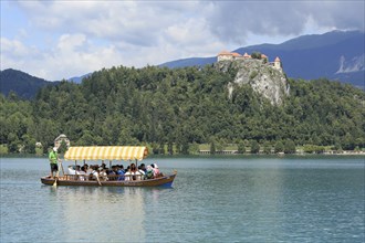 SLOVENIA, BLED, JULY 15, 2019: Traditional turist boat. Beautiful mountain lake in summer with