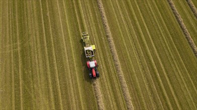 A tractor with a straw baler in a field