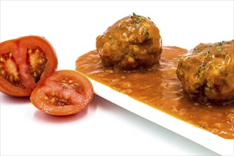 Meatballs cooked in tomato sauce on a white background