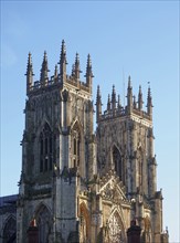 A view of the towers at the front of york minster in sunlight