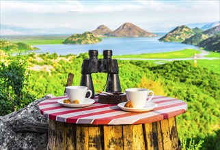 Binoculars and cups of coffee with the view on Scadar lake, Montenegro, Europe