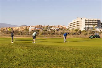 Two golf players on a course near Santa Cruz on the island of Tenerife