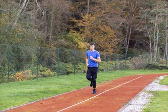 Young man jogging in the morning outdoor on the running race track