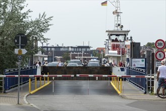 Cars and tourists leaving the car ferry in the harbour on the Priwall, seaside resort of