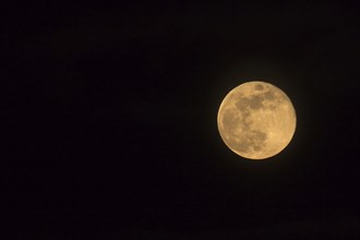 Blue Moon rising on 31 March 2018, landscape orientated image with Moon isolated on black