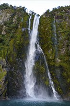 A waterfall at Milford Sound, Fiordland National Park, New Zealand, Oceania