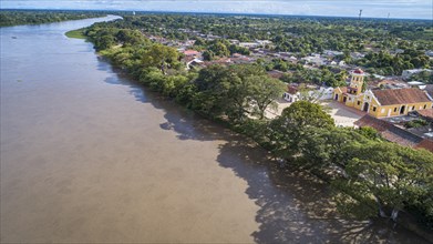 Aerial view of the historic town Santa Cruz de Mompox in sunlight with river and Iglesia De Santa