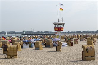 Summer weather, bathers, beach chairs and DLRG lifeguard tower on the beach, Travemünde beach,