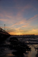 Sunset at the pier on the beach in Palanga, Lithuania, Europe