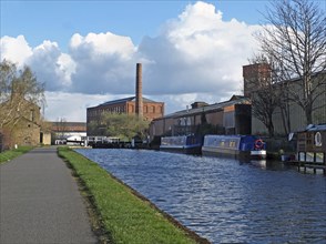 Oddy locks on the leeds to liverpool canal with the historic castleton mill in the background