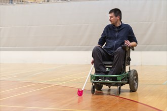 Photo of disabled man on a wheelchair playing sports, hockey, International wheelchair amputee