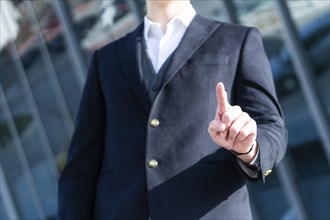 Photo of Business Man pushing on a touch screen interface