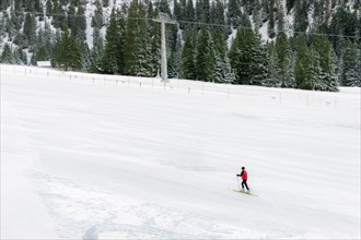 Minimal style winter landscape with ski slope full of snow, surrounded by snowy fir trees, and a