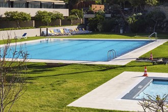 A rectangular swimming pool and another smaller one in a garden of the island of Tenerife