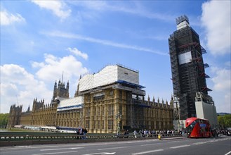 The Palace of Westminster as the Houses of Parliament on the north bank of the River Thames in