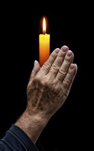 Praying hands with a candle