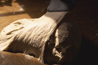 Bread sourdough on a kitchen counter in natural light. Close-up of white flour dough. Fermented