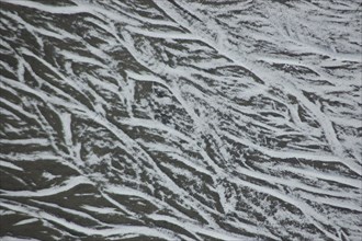 Pattern of snow in braided river bed near Lake Coleridge, Canterbury, New Zealand, Oceania