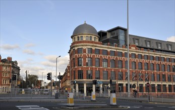 Leeds, England, January 11, 2018: man crossing the road and traffic on new york road and north