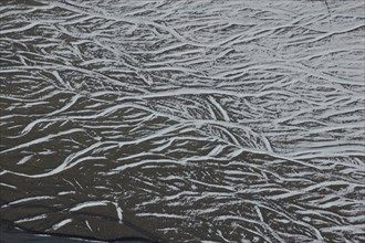 Pattern of snow in braided river bed near Lake Coleridge, Canterbury, New Zealand, Oceania