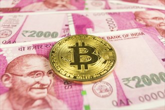 Cryptocurrency Bitcoin on Indian rupee bills