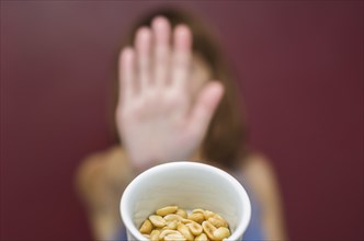 Great concept of food allergy, allergy to peanut, woman denying peanut