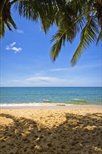 Sand beach with palms and canoes in Phu Quoc close to Duong Dong, Vietnam, Asia