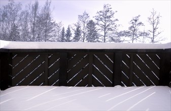 Beautiful winter scenery from a german house balcony with wooden railing, all covered with fluffy