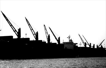 A row of loading cranes on an industrial vessel in Kaohsiung port