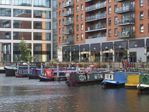 Leeds, west yorkshire, united kingdom, 16 july 2019: a view of of leeds dock houseboats and barges