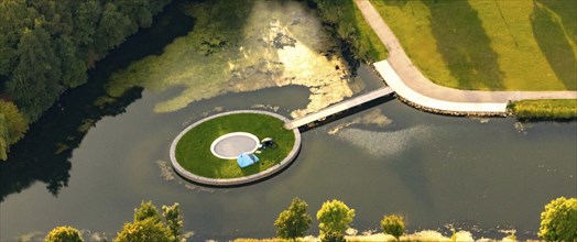 Lone angler on an artificial island in a lake