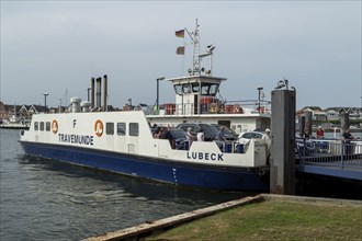 Cars and tourists leaving the car ferry in the harbour on the Priwall, seaside resort of