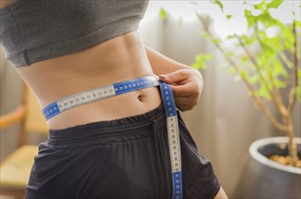 Close up of fit woman torso after workout. Female with perfect abdomen muscles