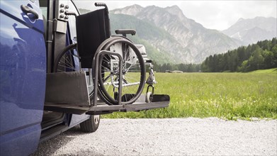 Photo of black electric lift specialized vehicle for people with disabilities. Empty wheelchair on