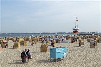 Summer weather, bathers, beach chairs and DLRG lifeguard tower on the beach, Travemünde beach,