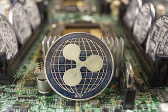 Ripple coin close-up on a computer circuit motherboard as a blockchain technology payment network.