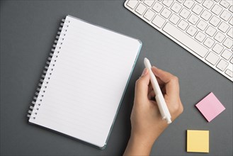 Keyboard Over A Table Beside A Notebook And Pens With Sticky Notes