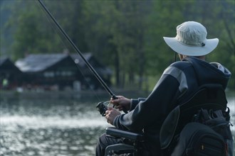 Young man in a wheelchair fishing