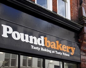 Leeds, west yorkshire, united kingdom, 7 july 2021: sign and slogan above the entrance of the pound