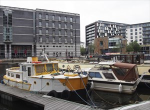 Leeds, west yorkshire, united kingdom, 1 july 2019: boats moored on the jetty at leeds dock with