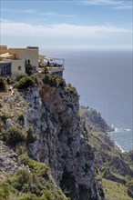 Terrace of a restaurant in Majorca built on a cliff overlooking the Mediterranean Sea